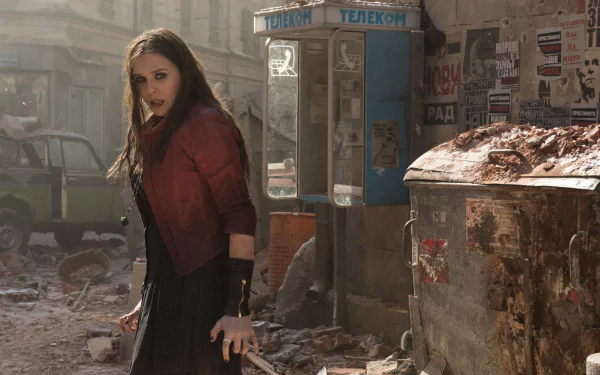 Scarlet Witch, portrayed by Elizabeth Olsen, stands confidently amidst a chaotic urban backdrop in this HD wallpaper from Avengers: Age of Ultron.