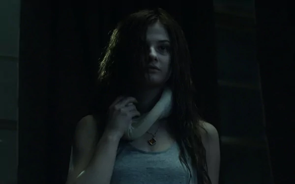 A dramatic HD wallpaper featuring Stefanie Scott in a scene from Insidious: Chapter 3, highlighting her intense expression and haunting atmosphere.