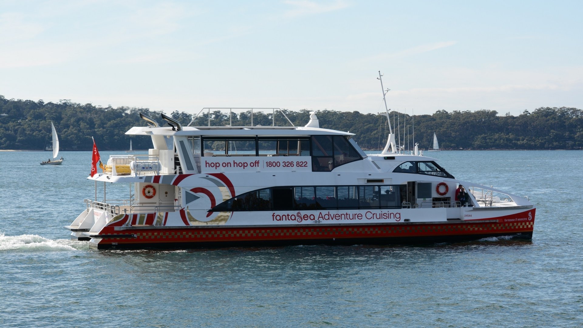 A catamaran ferry cruising on Sydney Harbour, Australia, captured in HD as a desktop wallpaper and background.