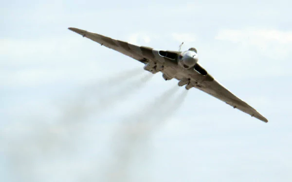 HD desktop wallpaper featuring a military Avro Vulcan bomber aircraft in flight against a clear sky.