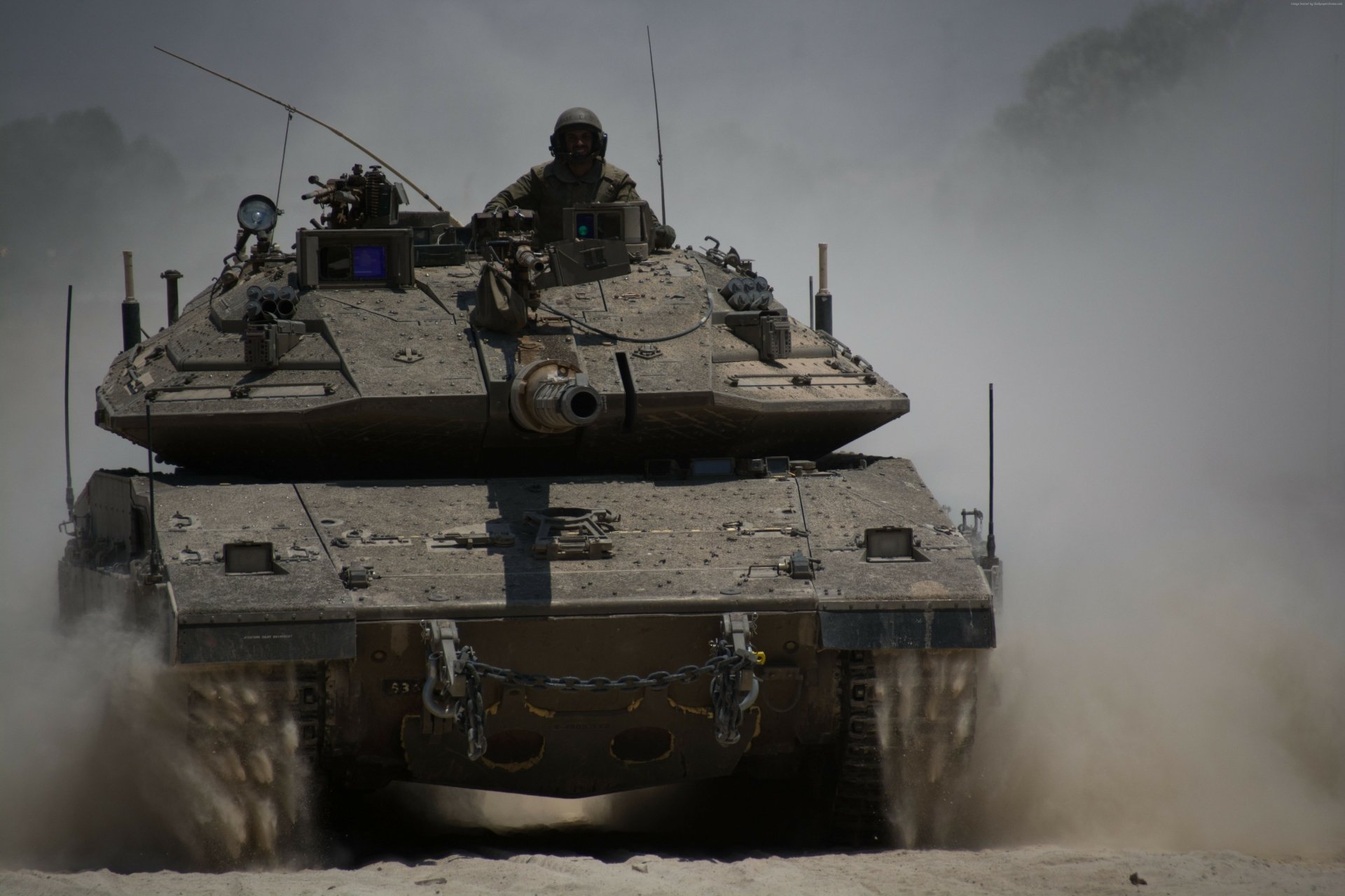 4K Ultra HD image of a Merkava tank advancing through dust, showcasing its robust military design and firepower from a frontal view.