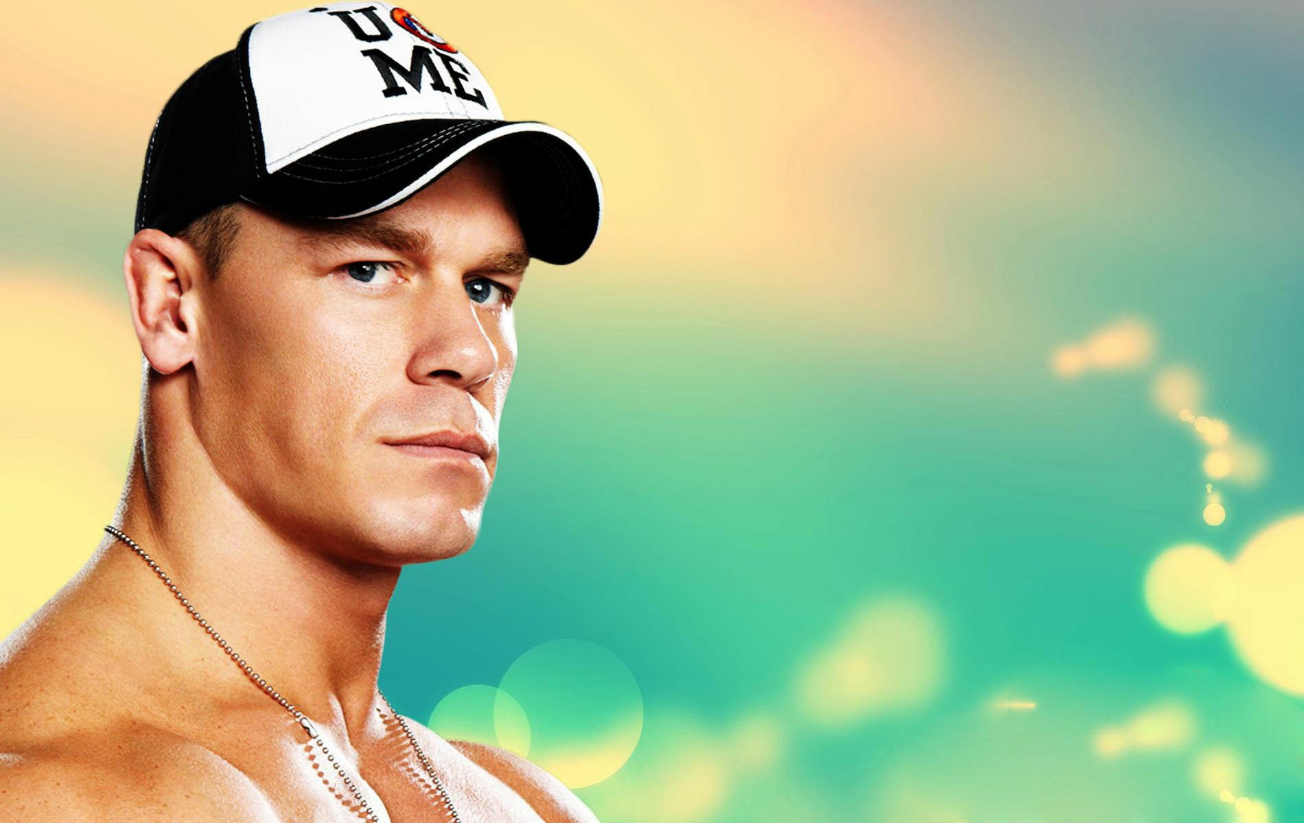 HD wallpaper featuring a serious WWE superstar in a U Can't See Me cap against a vibrant background.