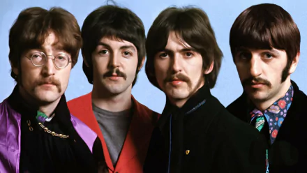 A vibrant HD wallpaper featuring The Beatles, showcasing the iconic band members in a colorful and artistic pose against a light blue background.
