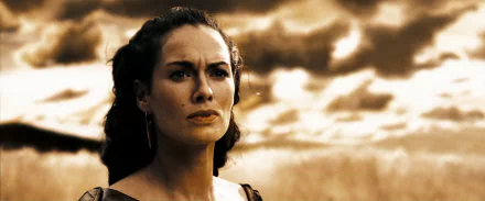HD wallpaper of Lena Headey as Queen Gorgo from the movie 300, featuring a dramatic sky background.
