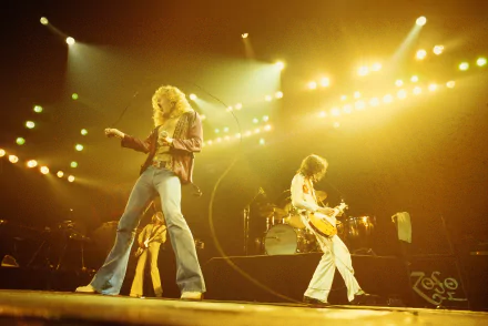 A dynamic live performance by Led Zeppelin, showcasing the band's energy and stage presence, captured in a vibrant 4K Ultra HD desktop wallpaper and background.