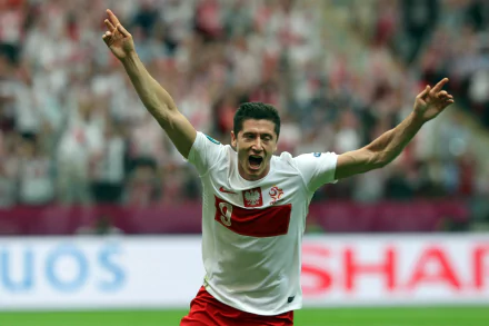 HD desktop wallpaper of Polish soccer player Robert Lewandowski celebrating on the field in his national team jersey.