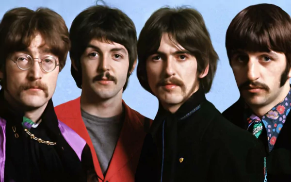 A vibrant HD wallpaper featuring The Beatles, showcasing the iconic band members in a colorful and artistic pose against a light blue background.
