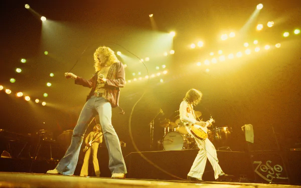 A dynamic live performance by Led Zeppelin, showcasing the band's energy and stage presence, captured in a vibrant 4K Ultra HD desktop wallpaper and background.