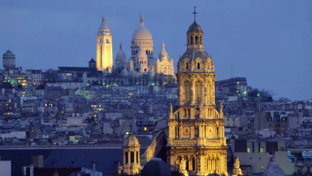 Illuminated Basilica of the Sacred Heart (Sacré‑Cœur) on Montmartre overlooking Paris at dusk — HD desktop wallpaper of France's man-made architectural skyline.