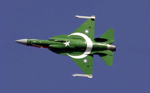 An HD PC desktop wallpaper featuring a CAC/PAC JF-17 Thunder fighter jet soaring through a clear blue sky, adorned in a striking green livery with a white crescent and star.
