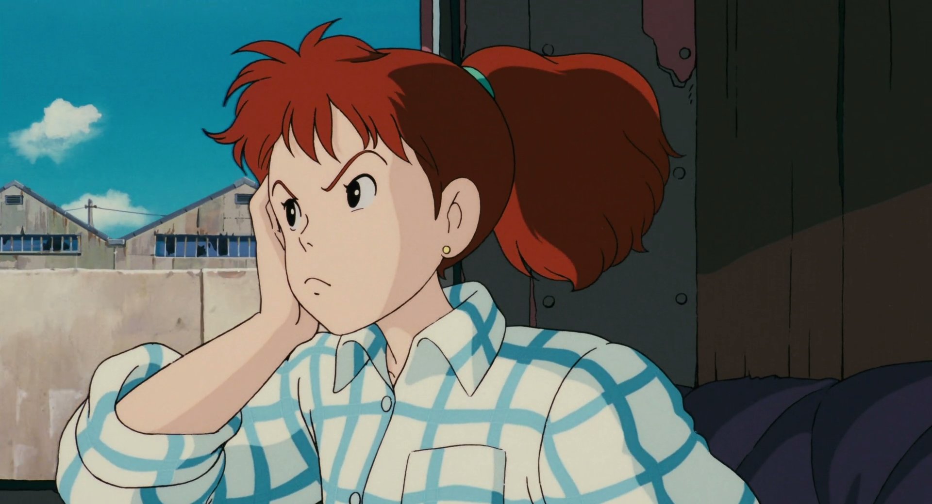 Studio Ghibli Anime (Porco Rosso) HD PC desktop wallpaper: red-haired mechanic Fio in a blue checkered shirt, leaning on her hand and frowning inside a seaplane.