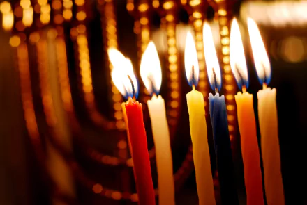 Close-up of brightly lit Hanukkah candles glowing warmly, captured in stunning 4K Ultra HD for a vibrant holiday PC desktop wallpaper.