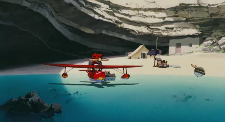 Anime-style HD PC desktop wallpaper from Porco Rosso, featuring a red seaplane floating near a rocky cave and beach with clear blue water.
