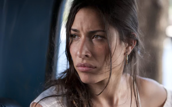 Close-up of a young woman with intense expression, from the movie *The Expendables*. This image serves as a cinematic 4K Ultra HD desktop wallpaper.