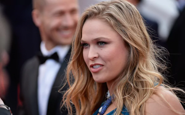 HD desktop wallpaper featuring Ronda Rousey, the renowned sports figure, captured in a candid moment at an event.
