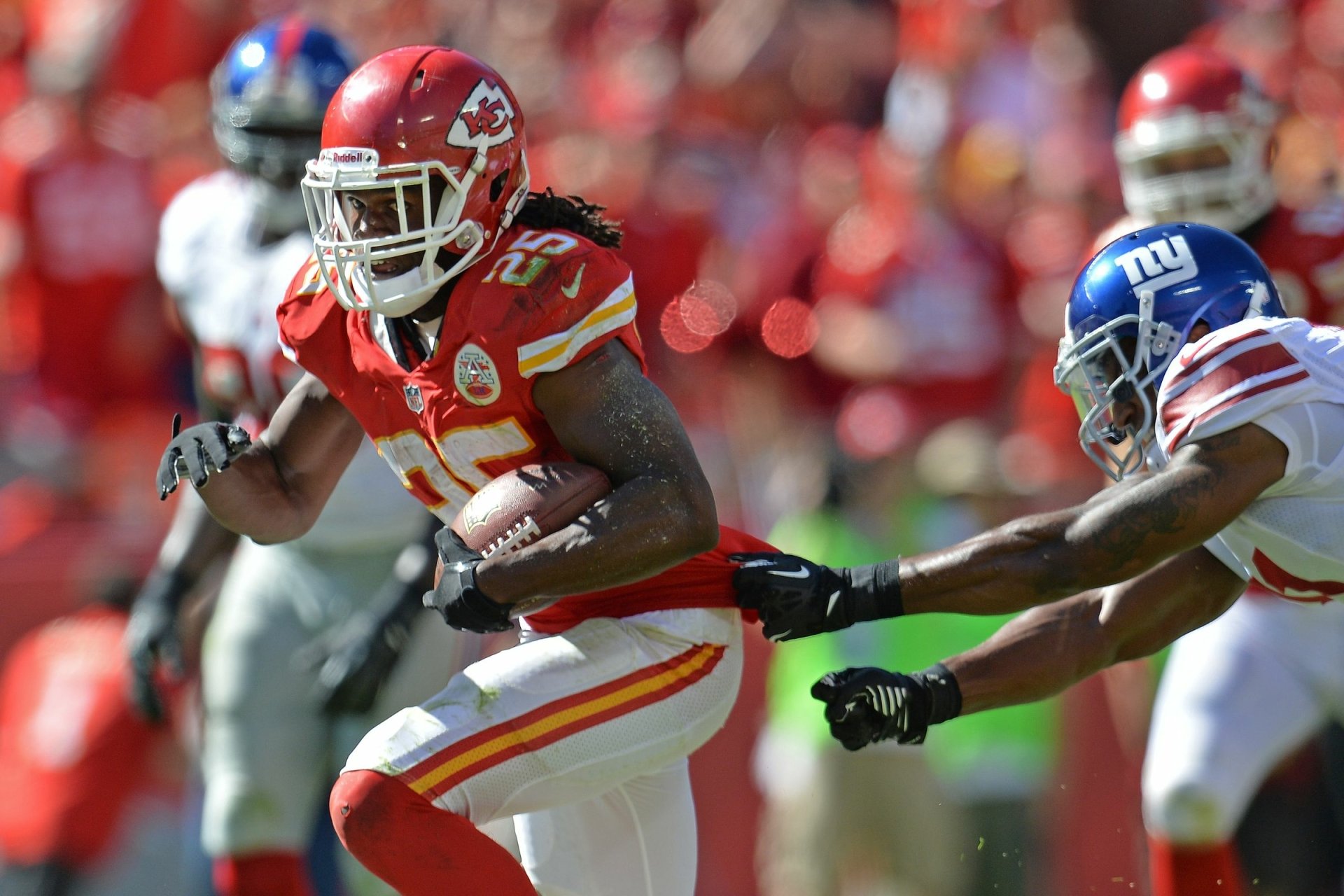 Kansas City Chiefs ballcarrier bursts past a New York Giants defender in high-energy sports action — HD PC desktop wallpaper/background.
