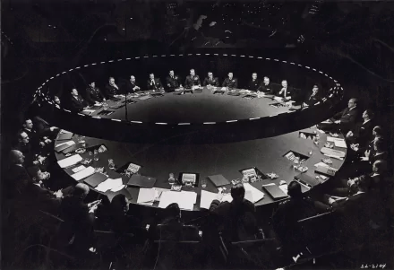 HD PC desktop wallpaper featuring the iconic War Room scene from the movie Dr. Strangelove with a large round table surrounded by men in suits.