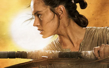 HD desktop wallpaper of Daisy Ridley as Rey from Star Wars Episode VII: The Force Awakens, showcasing an intense side profile with Rey holding her staff against a bright, sandy background.