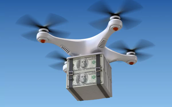 A drone carrying a money-filled box hovers against a clear blue sky, showcasing a striking man-made scene in this 4K Ultra HD desktop wallpaper.