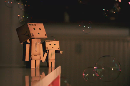 A 4K Ultra HD PC desktop wallpaper featuring two Danbo figures holding hands amid softly glowing bubbles in a dimly lit, cozy setting.