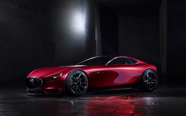 Sleek red Mazda RX-Vision concept car showcased in a dark setting, captured in 4K Ultra HD as a stylish PC desktop wallpaper and background.