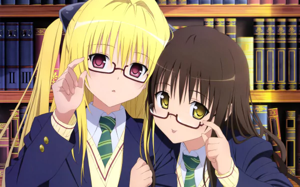 A blonde girl with long hair and glasses, alongside a girl with brown eyes and darker hair, both in school uniforms, pose together in a library setting. From the anime To Love-Ru.