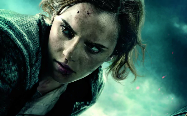 Hermione Granger, portrayed by Emma Watson, is featured in this HD wallpaper from *Harry Potter and the Deathly Hallows: Part 1*, showcasing her determined expression and resilience.