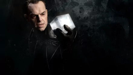 HD PC desktop wallpaper from Captain America: The First Avenger — a brooding villain holds a glowing cosmic cube against a smoky, dark textured background.