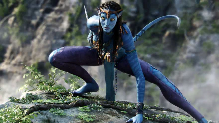 HD desktop wallpaper featuring a dynamic movie scene from Avatar, depicting a blue Na'vi character crouched on a rugged, moss-covered rock with a forested background.