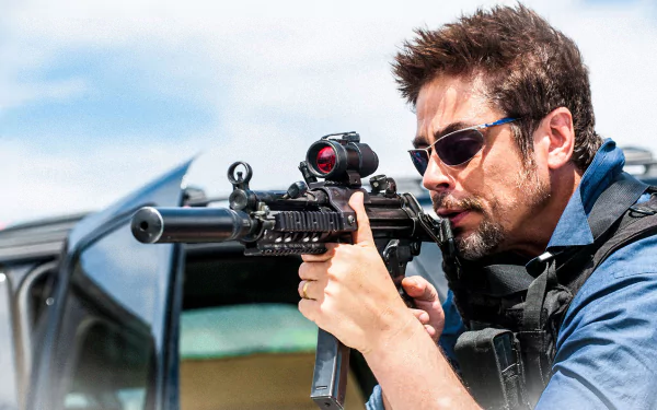 HD PC desktop wallpaper/background from the movie Sicario: armed man in sunglasses and tactical gear aims a rifle from an open vehicle against a bright sky.