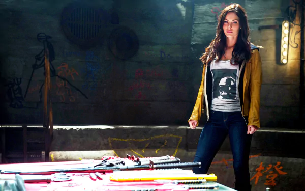 HD PC desktop wallpaper featuring a scene from the 2014 movie Teenage Mutant Ninja Turtles with a female character standing confidently in a dimly lit urban setting.