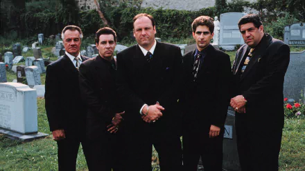 HD PC desktop wallpaper of five suited men standing in a cemetery, cinematic mob-drama TV show atmosphere.