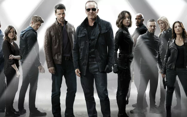 A dynamic HD wallpaper featuring the main characters of Marvel's Agents of S.H.I.E.L.D., standing together in a striking, heroic pose against a dramatic backdrop.