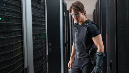 HD PC desktop wallpaper featuring Tom Cruise in a scene from the movie Mission: Impossible - Ghost Protocol, dressed in tactical gear within a server room.