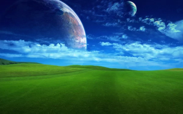 A vibrant HD desktop wallpaper featuring a lush green hill beneath a deep blue sky with two distant planets, evoking a dreamy, otherworldly nature scene.