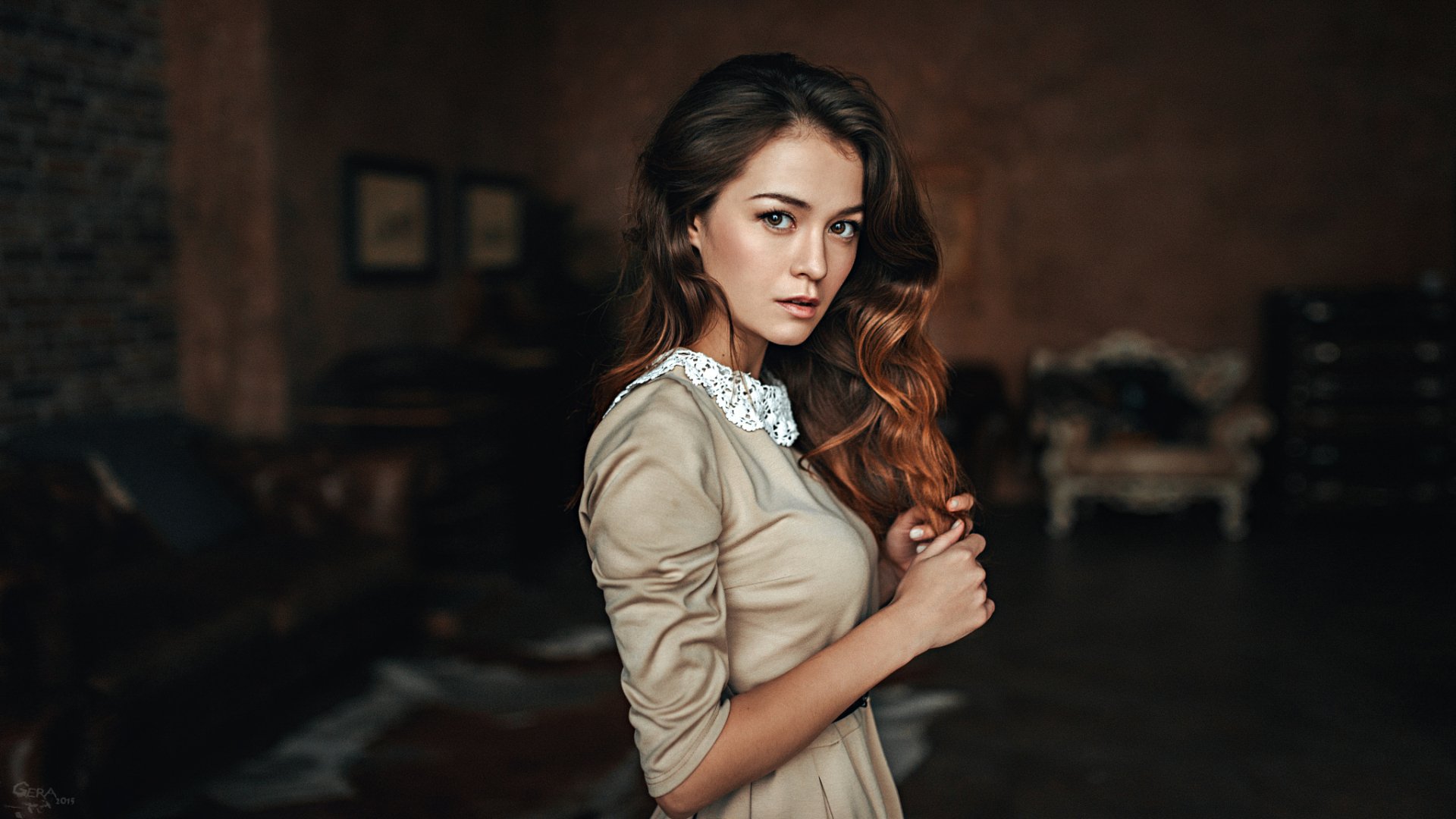 HD desktop wallpaper featuring a brunette woman with brown eyes, styled as a model, against a bokeh background.