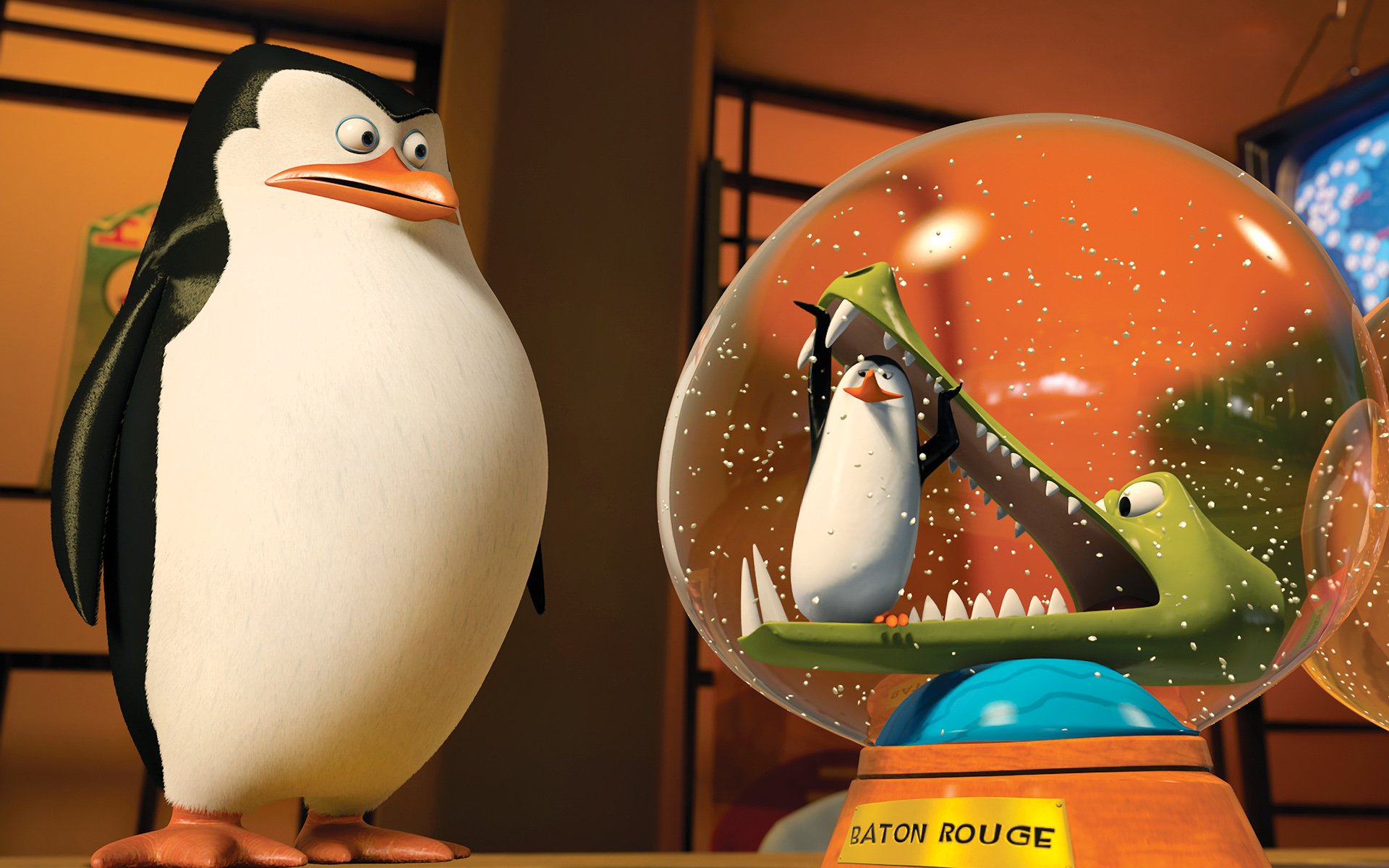 HD PC desktop wallpaper from the movie Penguins of Madagascar: a penguin stands beside a glass dome holding another penguin and a toothy crocodile.