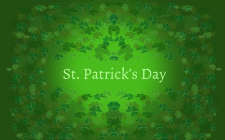 HD desktop wallpaper featuring green clovers surrounding the text St. Patrick's Day on a gradient green background, celebrating the holiday.