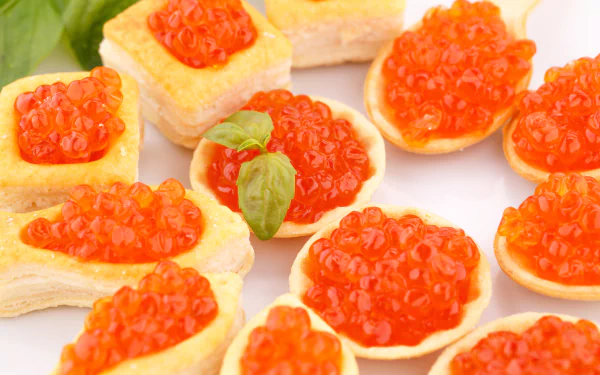 5K Ultra HD PC desktop wallpaper: close-up of bright red fish caviar on egg-based canapés and small pastry shells, garnished with basil.