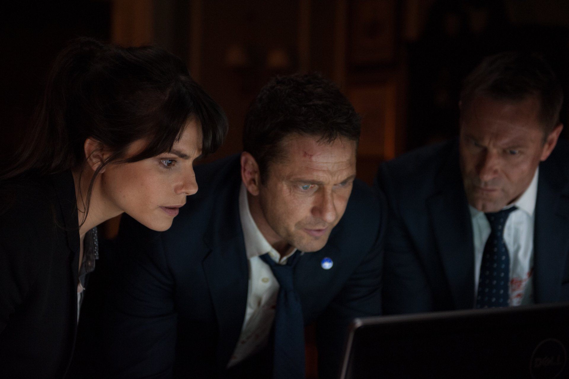 Charlotte Riley, Aaron Eckhart, and Gerard Butler appear focused in a scene from the 4K Ultra HD movie London Has Fallen, featuring characters Benjamin Asher and Mike Banning.