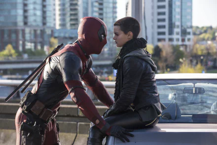 Deadpool interacts closely with Negasonic Teenage Warhead, played by Brianna Hildebrand, in this HD wallpaper from the movie Deadpool.