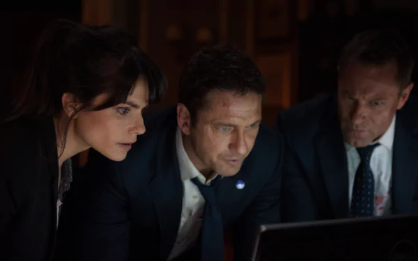Charlotte Riley, Aaron Eckhart, and Gerard Butler appear focused in a scene from the 4K Ultra HD movie London Has Fallen, featuring characters Benjamin Asher and Mike Banning.