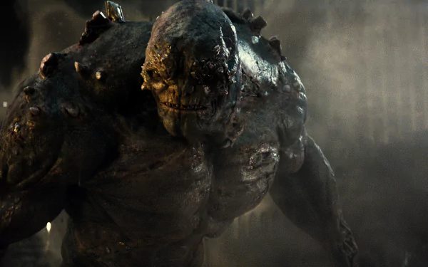 Doomsday, the fearsome creature from DC Comics, towers menacingly in a scene from *Batman V Superman: Dawn Of Justice*, presented as a high-definition desktop wallpaper.