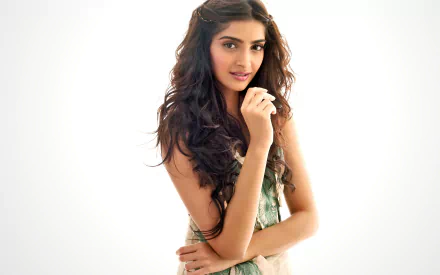 HD desktop wallpaper of an Indian actress with brown eyes and brunette hair, tagged with Celebrity, Sonam Kapoor. She stands confidently with a gentle smile against a light background.