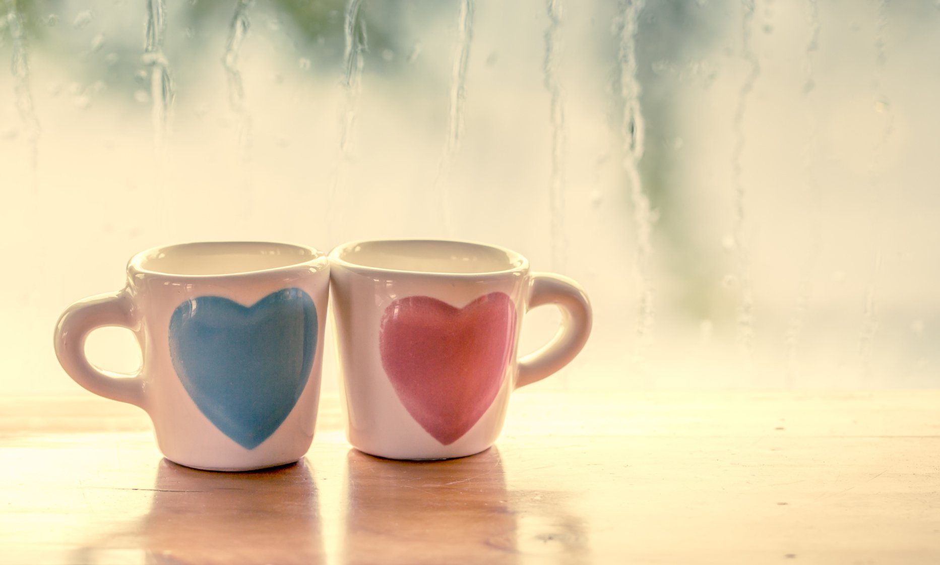 HD wallpaper of two cups with heart shapes, symbolizing love and romance, against a misty window background.