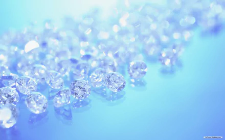 A stunning HD desktop wallpaper featuring a close-up of numerous sparkling diamonds on a smooth, light blue surface.