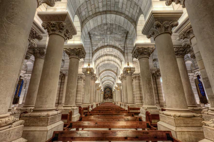 Interior view of a grand religious church in Madrid, Spain, showcasing stunning architectural columns and vaulted ceilings in high-definition detail.