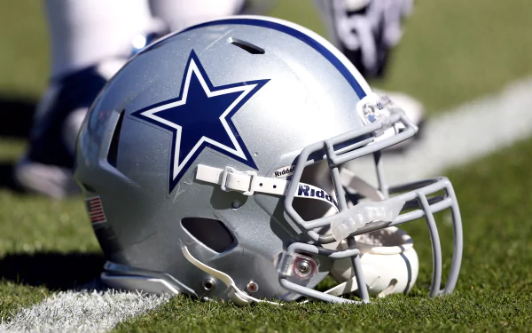 Dallas Cowboys football helmet on grass, captured in sharp 4K Ultra HD detail as a PC desktop wallpaper background.