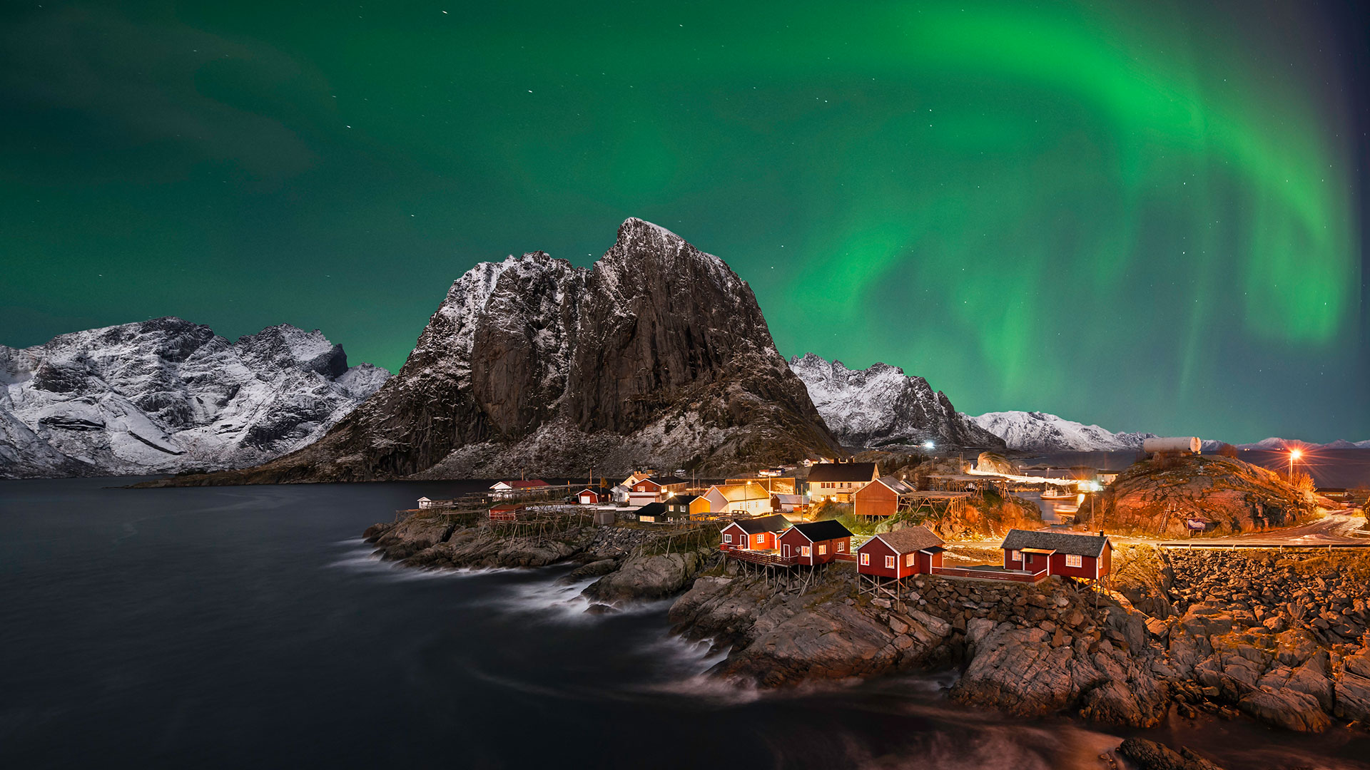 Northern Lights over Norwegian Village in Winter