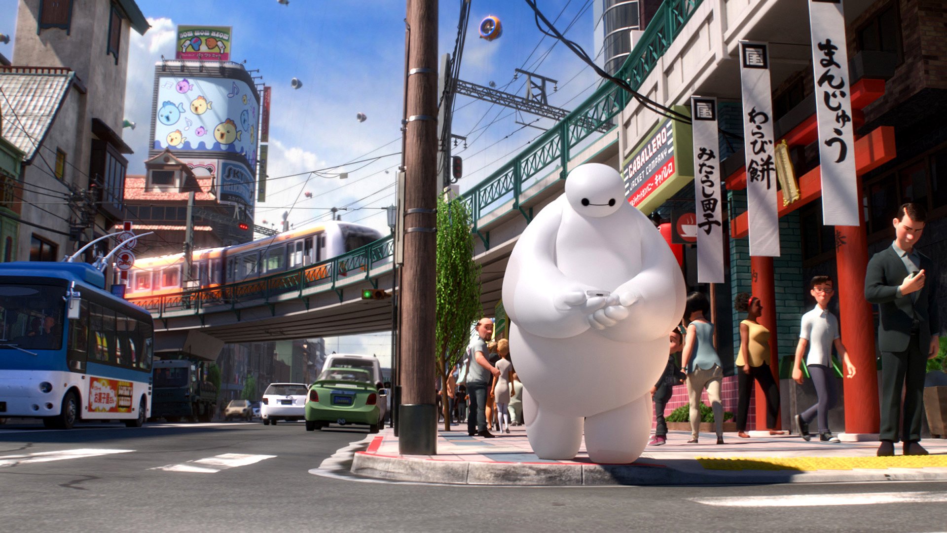 A vibrant HD desktop wallpaper featuring Baymax from Big Hero 6, showcasing a bustling city street with shops, public transport, and lively urban scenery.